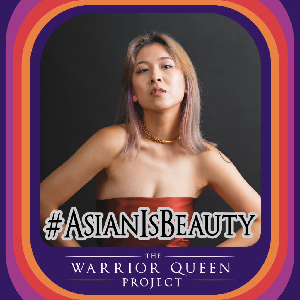 Rebecca Chen, a beautiful Asian Warrior Queen, models by voguing at the camera in a red strapless gown